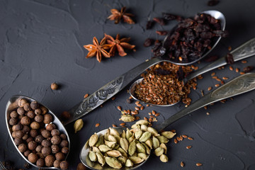 Various spices spoons on stone table.On dark concrete background.Herbs and spices on wooden table.