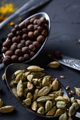 Various spices spoons on stone table.On dark concrete background.Herbs and spices on wooden table.