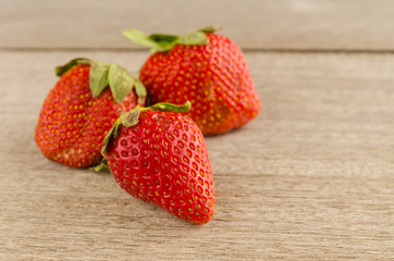 Fresh strawberries on old wooden background