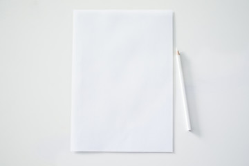 White a4 paper and pencil on white background