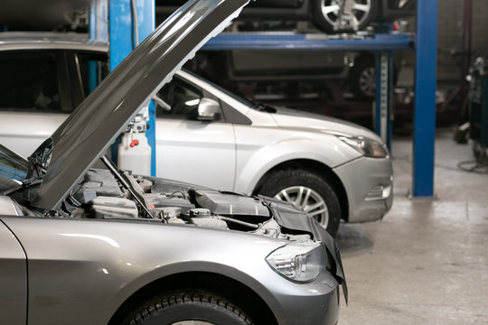 car repair station. cars stand in small service and repair one car.