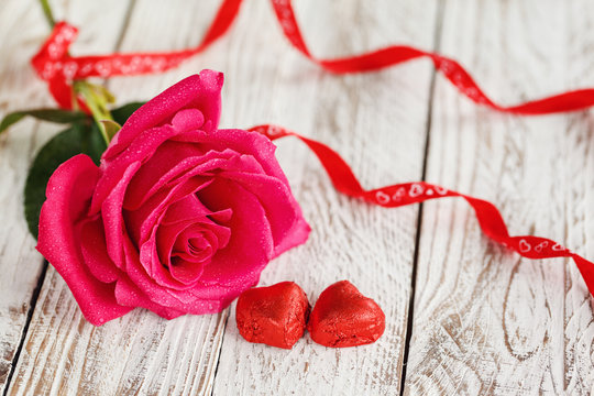 Beautiful pink rose on white table. Greeting card
