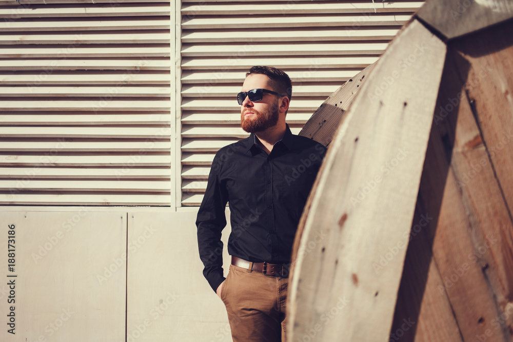 Wall mural Fashion portrait of a young hipster man outdoors