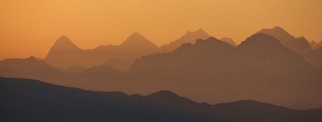 Fototapeta na wymiar Golden sunrise near Gstaad. Summer morning in the Swiss Alps.