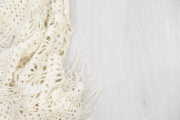 Flat lay of scarf with Christmas tartan texture and branch of tree on wooden background with space in middle - Christmas or New Year background