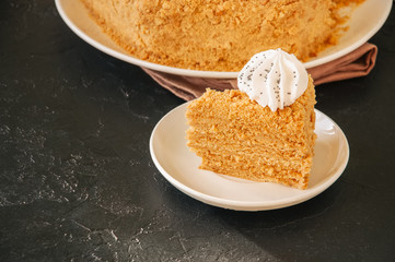 Honey cake with meringue decoration on top.
