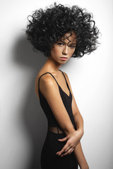 Beautiful woman with afro curls hairstyle © soup studio