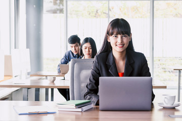 Businesswoman working on notebook computer and business document at office