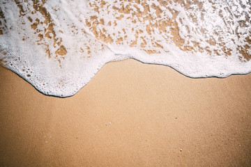 Fototapeta na wymiar Sea background. Soft wave of blue sea on sandy beach