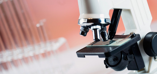 Microscope with lab glassware, science laboratory research concept