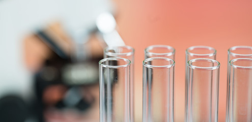 Microscope with lab glassware, science laboratory research concept