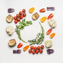 Flat lay of colorful salad vegetables ingredients with seasoning on white background, top view, frame.  Healthy clean eating layout, vegetarian food and diet nutrition concept