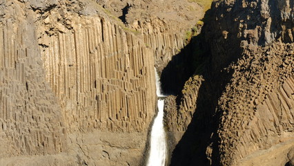 Waterfall that breaks through the basalt breed in Iceland