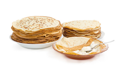 Thin pancake during rolling up with cottage cheese filling