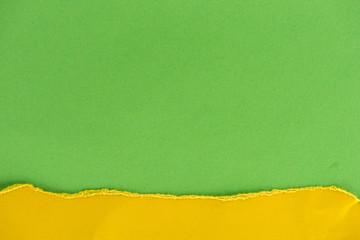 close-up shot of green and yellow paper layers for background
