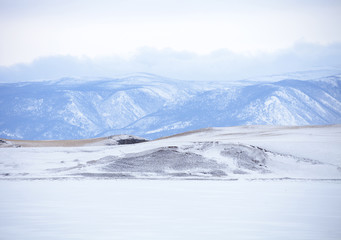 Baikal lake. Winter landscape. Snowy mountain peaks