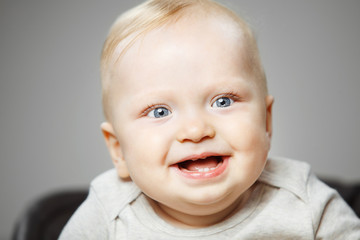 Baby with interested look and broad smile