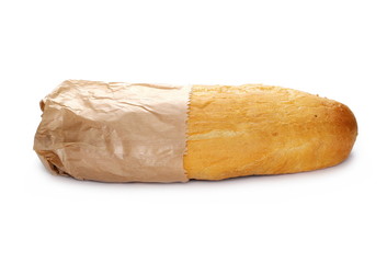 Loaf of wheat bread in paper bag isolated on white background