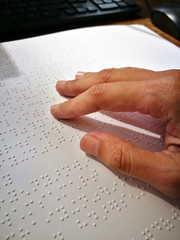Obraz premium Blind Woman Read Book Written In Braille. Close Up Finger Touch To Braille Code
