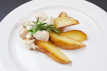 potatoes on rustic with chicken in a sauce