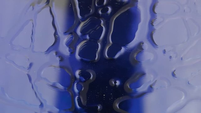 Blue surface, rotating under a glass, abstract background