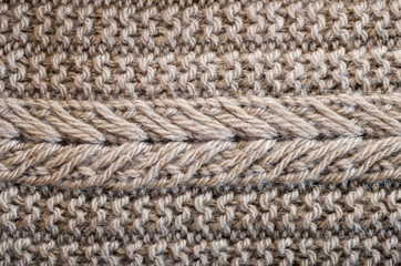 Knitted texture. Pattern fabric made of wool. Background, copy space
