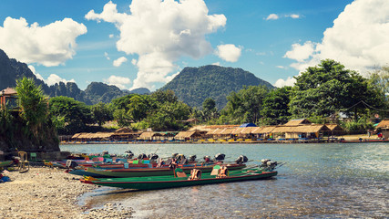 Fototapeta premium long tail boats on sunset at Song river, Vang Vieng, Laos.