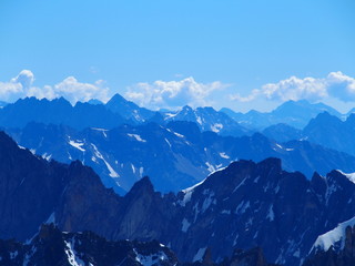 Fototapeta premium Alpine mountains range landscape in French ALPS seen from Aiguille du Midi at CHAMONIX MONT BLANC in FRANCE