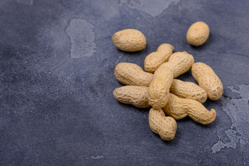 Closeup unpeeled  peanuts on stone background