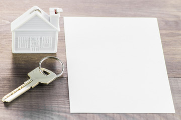 Net contract , a small house and a key on a wooden Board