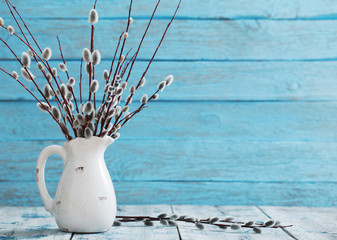 Bouquet of willow branches on a wooden background © Maya Kruchancova
