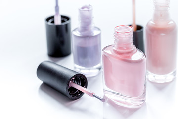 Bottles with nail polish over white background