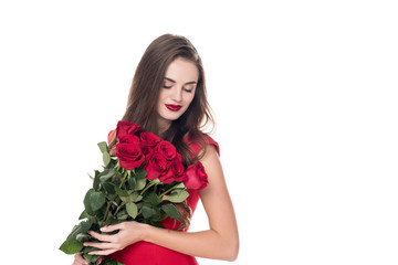 attractive girl standing with bouquet of red roses isolated on white