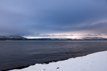 Cold winters day at a snow covered Loch Lomond Scotland