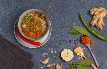 Indian vegetarian lentil soup, mung dal. Indian food spice concept. Dark background, top view. Vegan Healthy Food Concept.