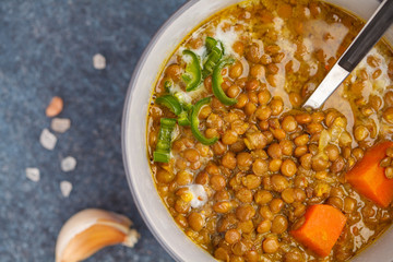 Indian vegetarian lentil soup, mung dal. Indian food spice concept. Dark background, top view. Vegan Healthy Food Concept, macro