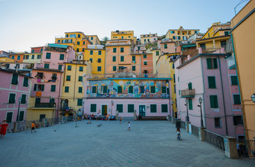 RIOMAGGIORE, ITALY, JULY 31, 2017 - Typical colored houses of Riomaggiore at sunset, 5 Terre, La Spezia province, Ligurian coast, Italy.