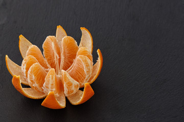 photo of a mandarin on a dark background. Restaurant menu.