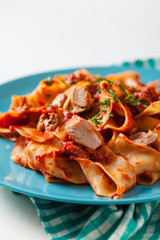 Pappardelle pasta with tuna, in tomato sauce.