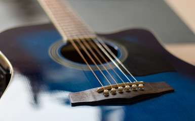 Fototapeta premium Acoustic guitar blue with shallw depth of field