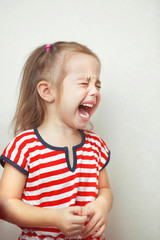 Child with tears falling down girls young face