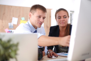 Obraz premium Young woman working in office, sitting at desk. Young woman. Partners
