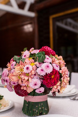 Wedding floristics. Decoration of a wedding table fresh red and pink flowers. Wedding in pink color