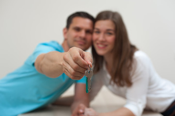 Blurred image of Happy married couple holding the keys to an apartment