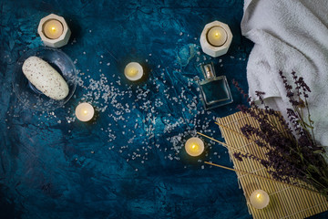 White Towel, Sea Bath Salt, Candles, Handmade Soap on a Dark Dark Blue Background