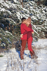 Loving couple in the winter wood