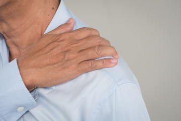 man suffering from neck, shoulder pain