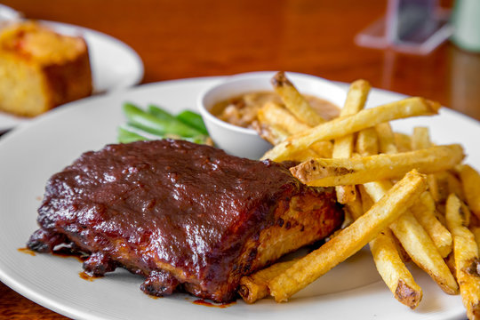 The pork steck with green soy bean fried potato and bean paste on the table , food set.