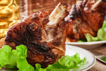 Roasted turkey knuckle with fried potato slices