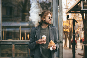 Portrait of a stylish bearded man dressed in coat
